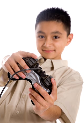 Child playing video games with a black controller over a white background