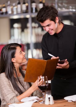 Woman ordering food to the waiter at a restaurant